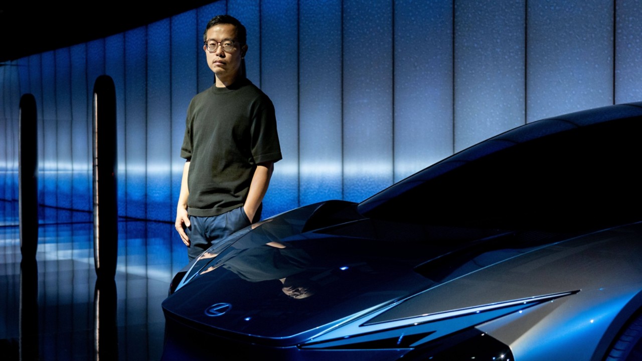 Hideki Yoshimoto stood next to a parked Lexus LF-ZC Concept Car