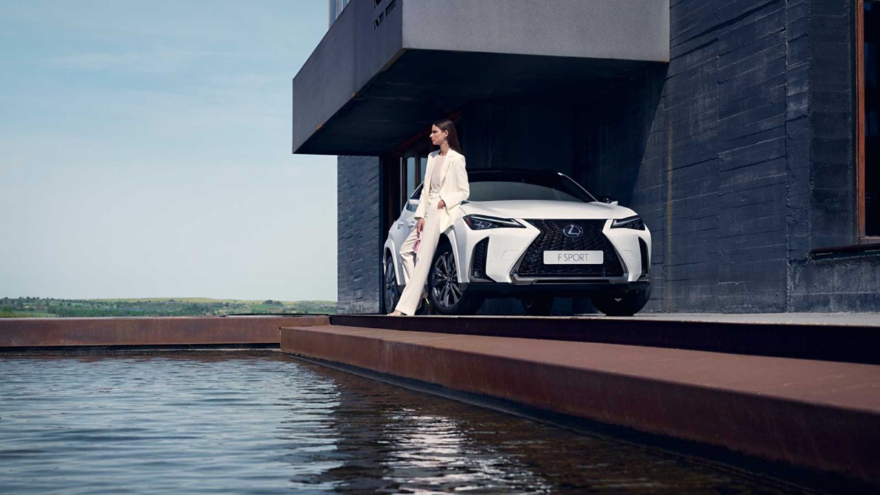 Lexus UX driving in a town location