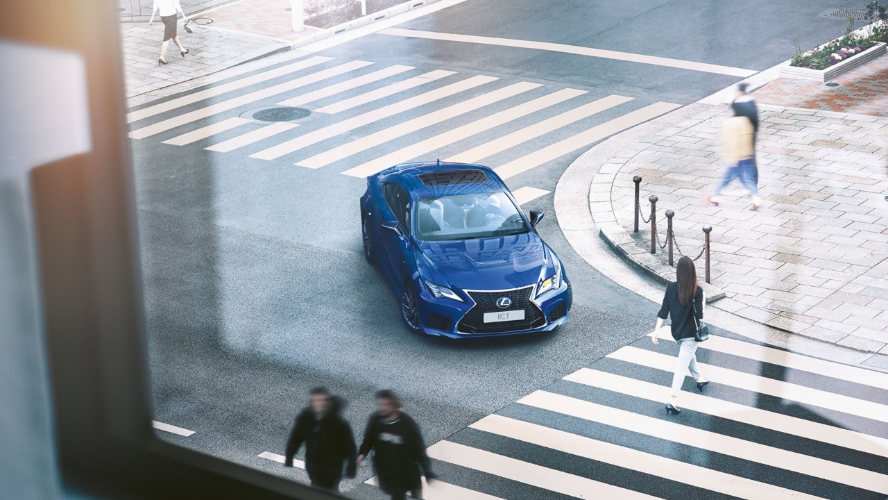 Lexus RC F waiting at a pedestrian crossing