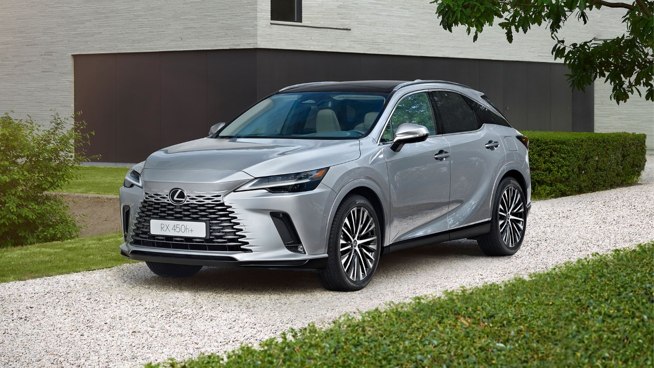 A Lexus RX 450h+ parked outside a building