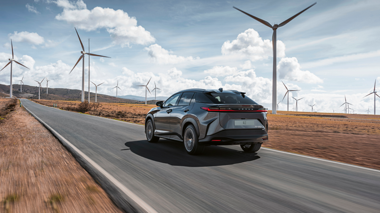 Lexus RZ driving through a wind farm