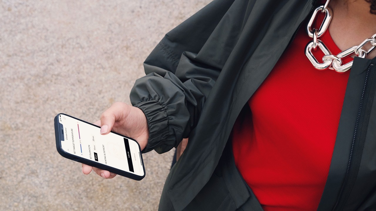 A woman using a mobile phone to access the Lexus Link app