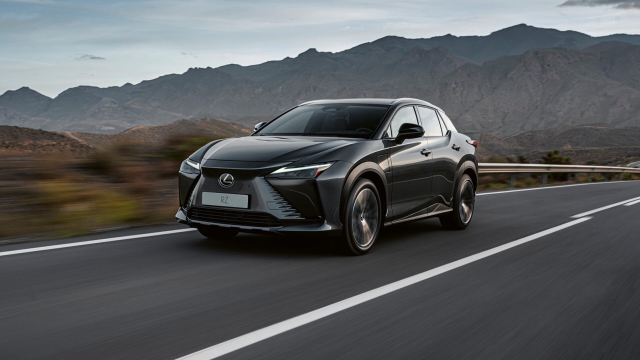 Side view of the Lexus RZ driving in a rural environment 