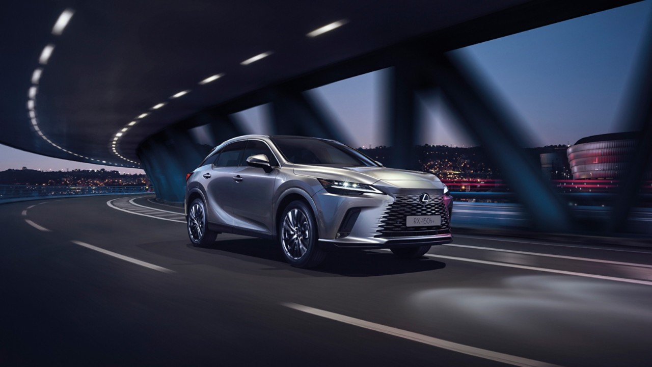 A Lexus driving under a bridge