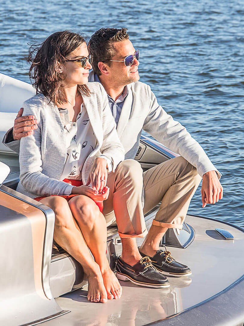 A man and woman sat on the stern of the Lexus Sports Yacht 