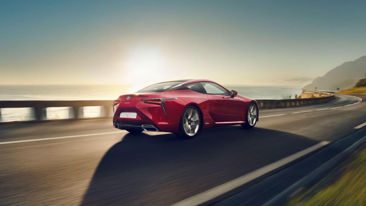 A Lexus LC driving on a coastal road 