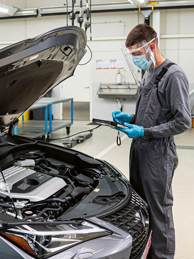 A Lexus staff member wearing personal protective equipment