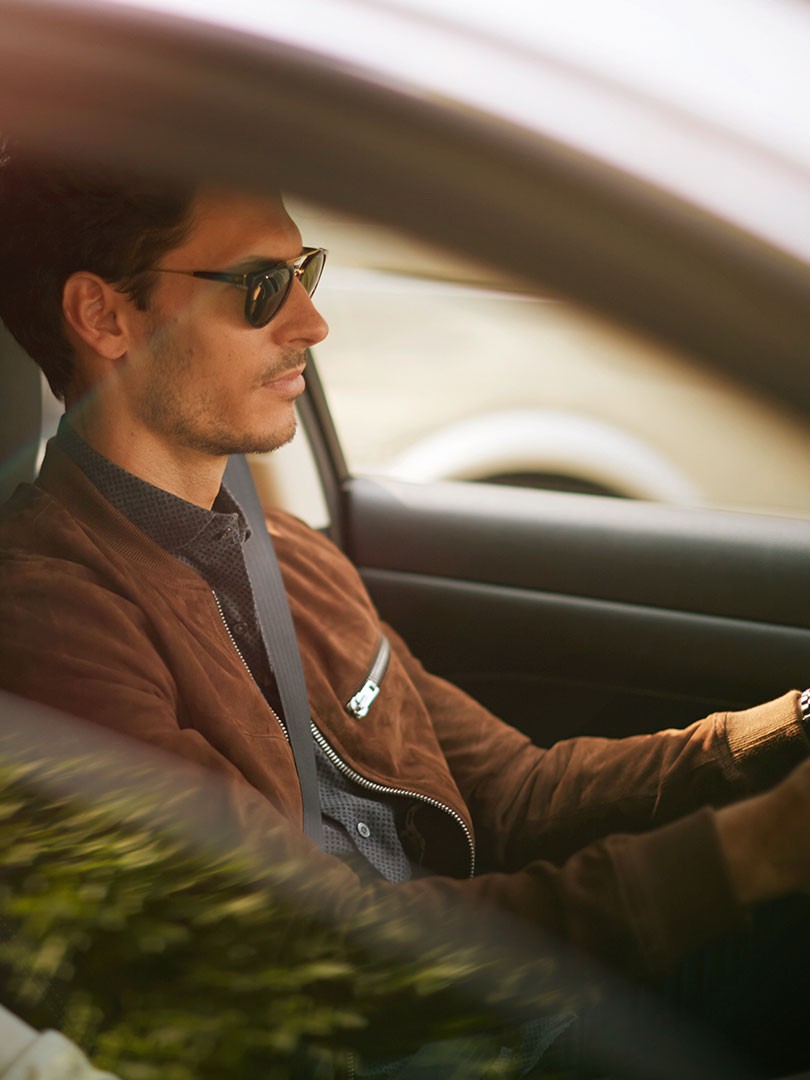 A man sitting in a Lexus 