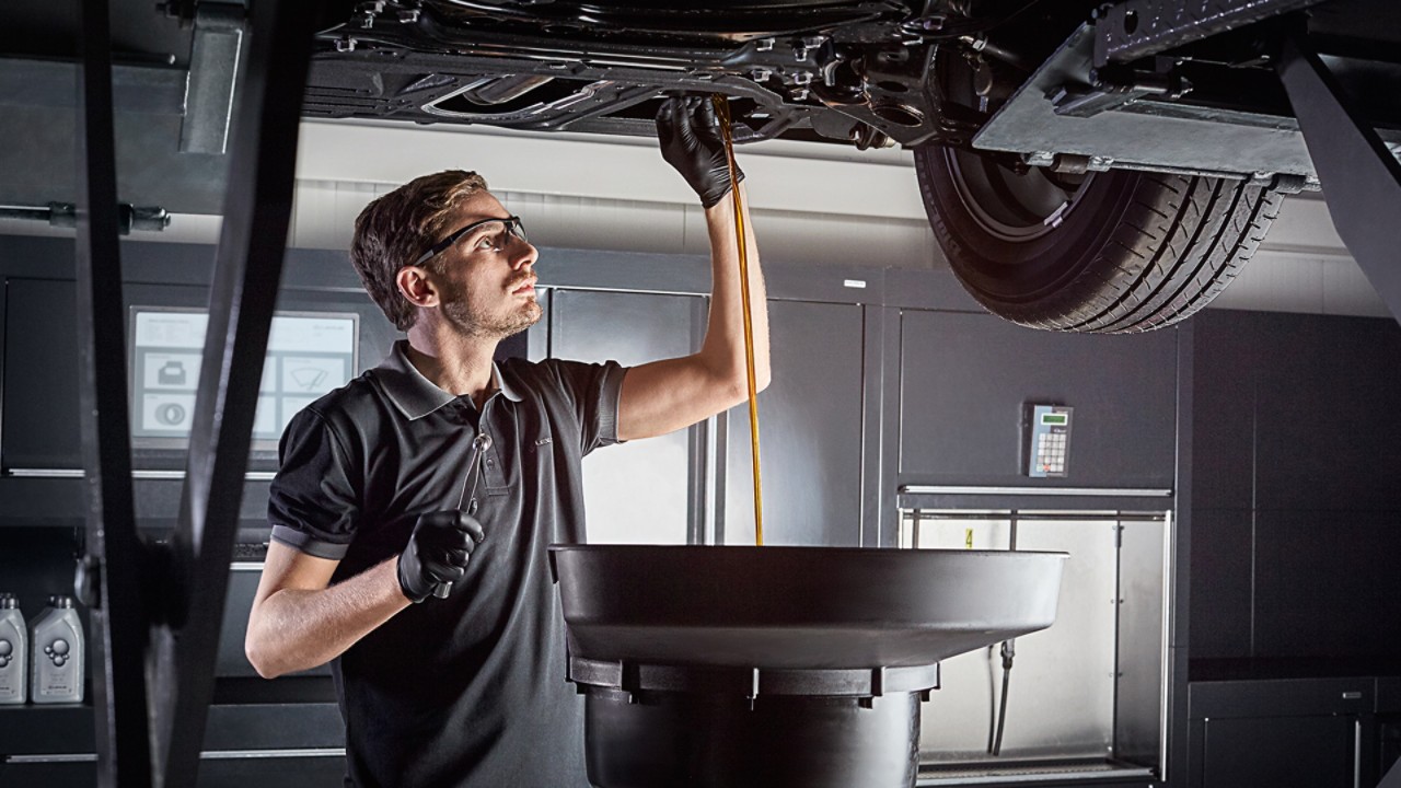 A Lexus mechanic changing a cars engine oil 