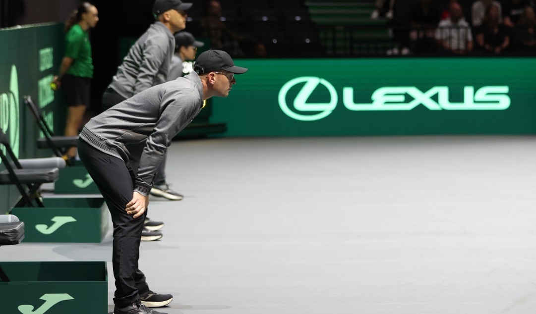 Line judges stood at the side of a tennis court