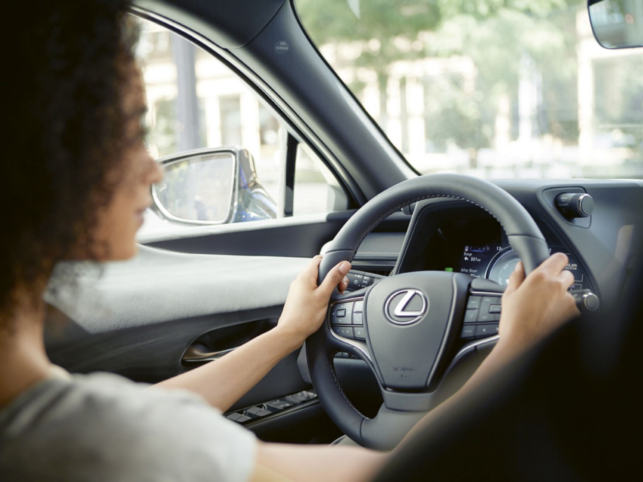 A woman driving a Lexus