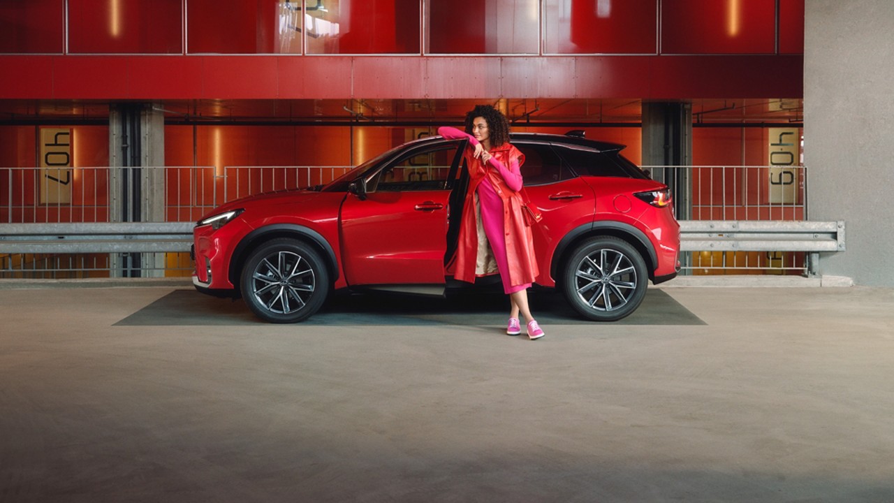 A man walking towards a Lexus