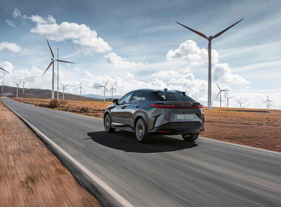 Lexus RZ driving through a wind farm