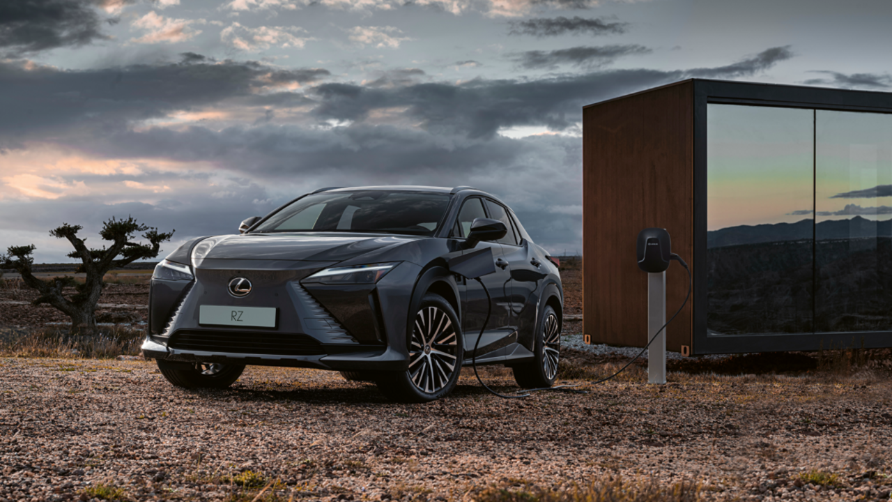 Lexus RZ plugged into a charging tower