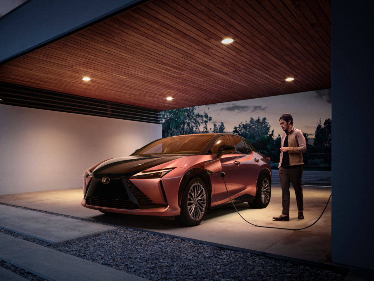 A Lexus RZ 450e plugged into a charging box