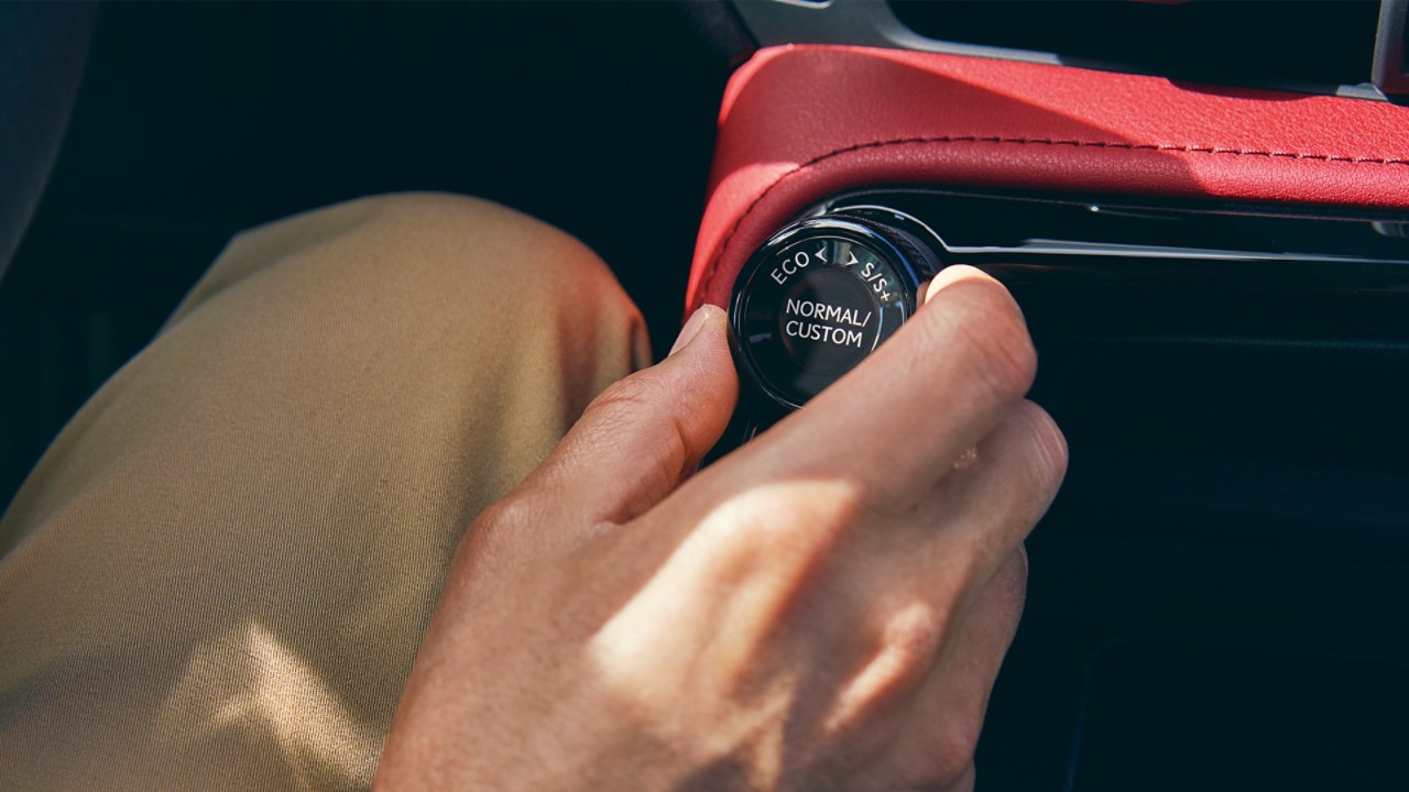 A person adjusting the drive setting of a Lexus 