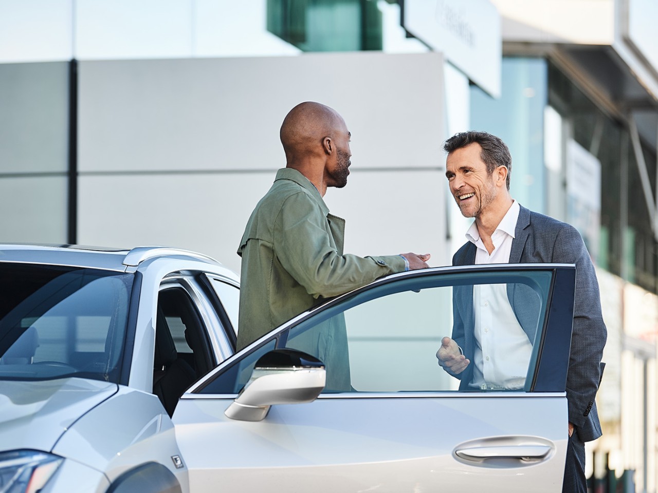 Two people interacting at a Lexus dealership 